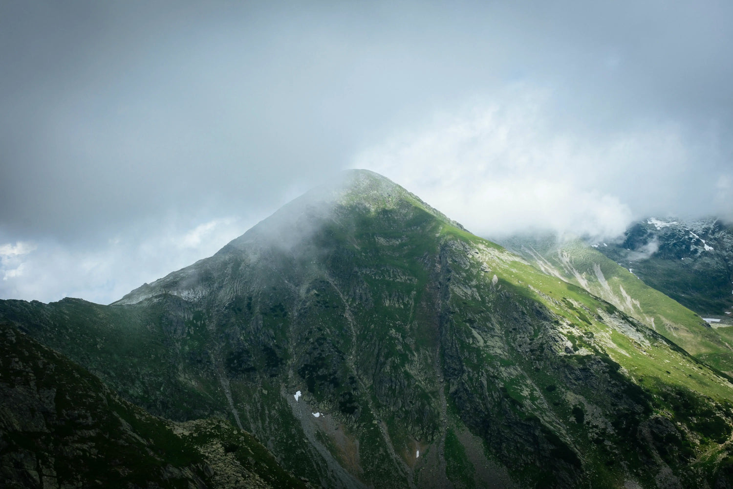 Mountain peak with clouds and mist on a cloudy day