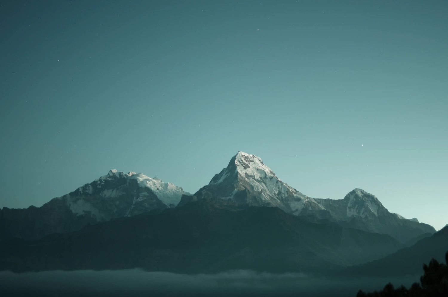 Mountain range with snow-capped peaks under a clear blue sky