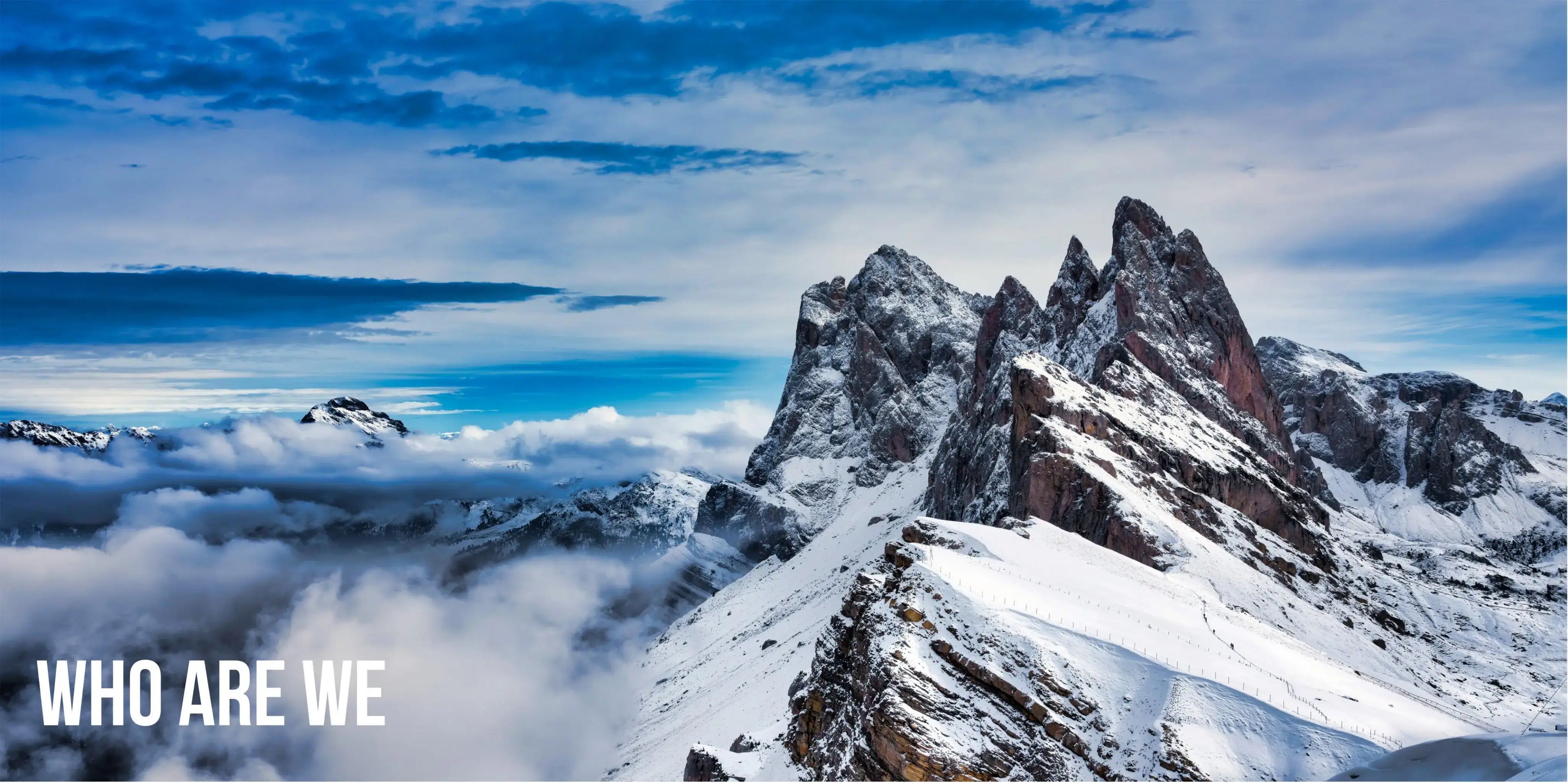 Snowy mountain peaks with clouds below and a blue sky above, featuring the text 'WHO ARE WE'.