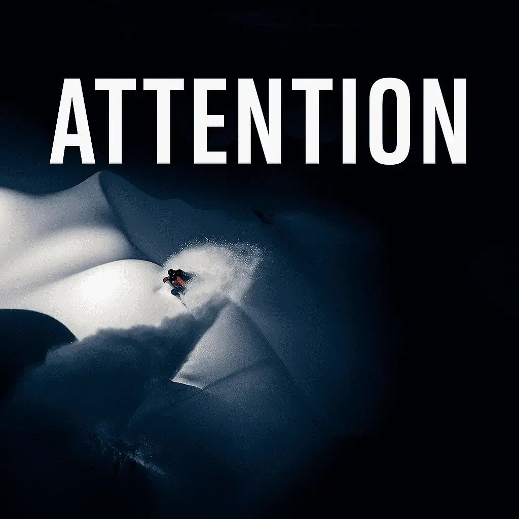 Person snowboarding down a snowy slope with the word 'ATTENTION' above.